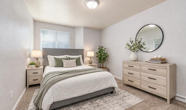 a bedroom with a large mirror